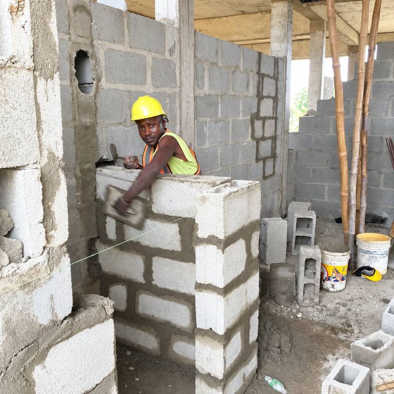 Ongoing Visitor's WC blockwork on Unit CR-7, with block laying guided by a builder's line to ensure proper alignment and straightness.